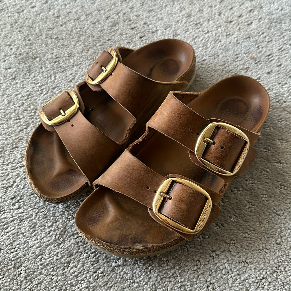 Brown Arizona Birkenstock sandals with big gold buckle